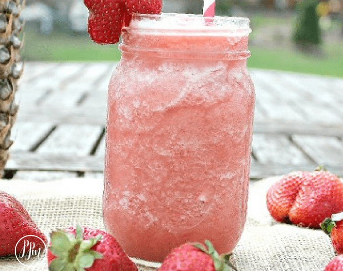 mason jar with pink smoothie and straw