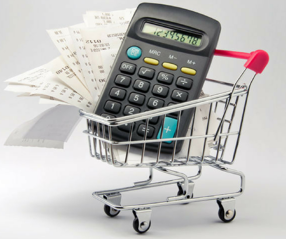 Calculator and receipt in shopping cart for grocery budget