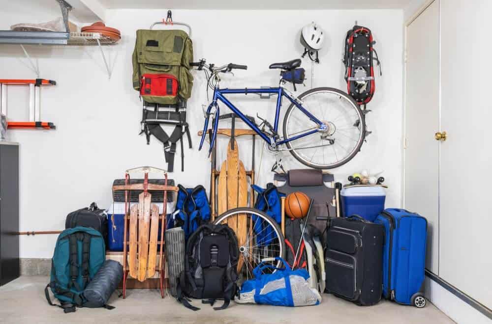 Travel gear, bikes, and equipment stored in garage
