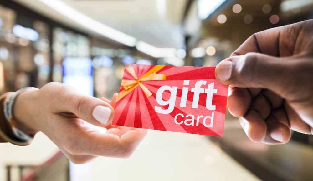 Giving Gift Card Or Voucher In Shopping Mall